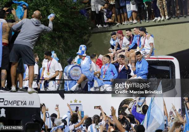 Lionel Messi of Argentina men's national football team and his teammates are welcomed by fans as they arrive to the teams headquarters after winning...