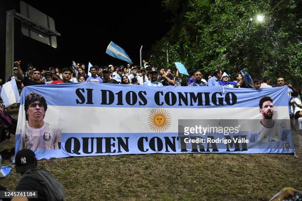 Fans of Argentina display a flag of Lionel Messi and late football legend Diego Maradona before the arrival of the Argentina men's national football...