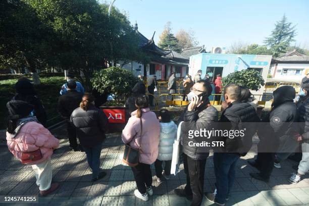 People visit a makeshift clinic transformed from a Covid-19 coronavirus testing booth in Hangzhou, in China's eastern Zhejiang province on December...