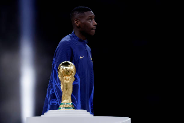 Randal Kolo Muani of France is passing dejected the world cup trophy after receiving the silver medal during the World Cup match between Argentina v...