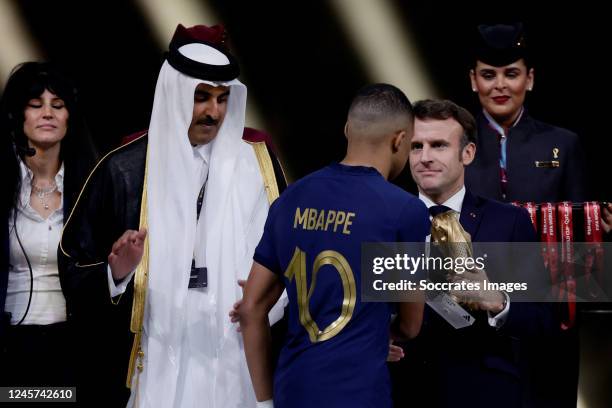 Kylian Mbappe of France receives the golden boot award out of the hands from President of France Emmanuel Macron as Sheikh Tamim Bin Hamad Al Thani...