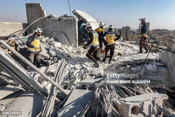 Syrian rescue teams inspect the damage at the site of an alleged US-led coalition drone strike in the opposition-held city of al-Bab, on the border...