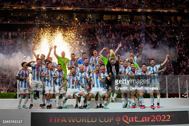 Lionel Messi of Argentina celebrates winning with his team and rises the trophy after the FIFA World Cup Qatar 2022 Final match between Argentina and...