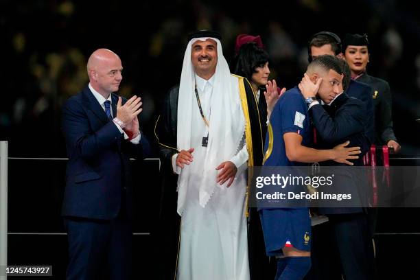 President Gianni Infantino, Hamad bin Khalifa Al Thani , Kylian Mbappe of France and President Emanuel Macron (France comfort after the FIFA World...