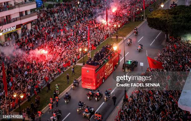 Supporters cheer as Morocco's national football team arrives to the center of the capital Rabat, on December 20 after the Qatar 2022 World Cup.