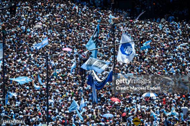 Multitude of Argentine celebrate with flags and chanting as they gather for the victory parade of the Argentina men's national football team after...