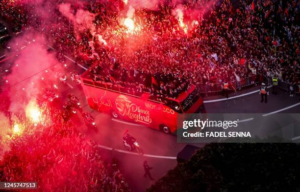 Supporters cheer as Morocco's national football team arrives to the center of the capital Rabat, on December 20 after the Qatar 2022 World Cup.