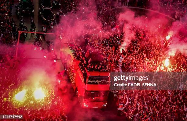 Supporters light flares and cheer as Morocco's national football team arrives to the center of the capital Rabat, on December 20 after the Qatar 2022...