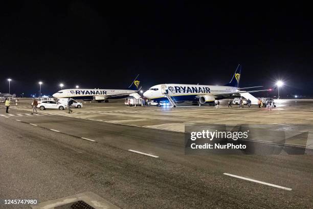 Night view of Boeing 787-800 aircraft or Boeing 737NG of the Irish low-cost carrier Ryanair on the apron of Paphos International airport while...