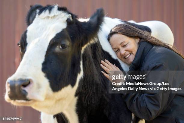 Santa Clarita , CA Ellie Laks, founder of The Gentle Barn hugs cow Holy Cow at the Santa Clarita animal rescue, Monday, Dec 19, 2022.