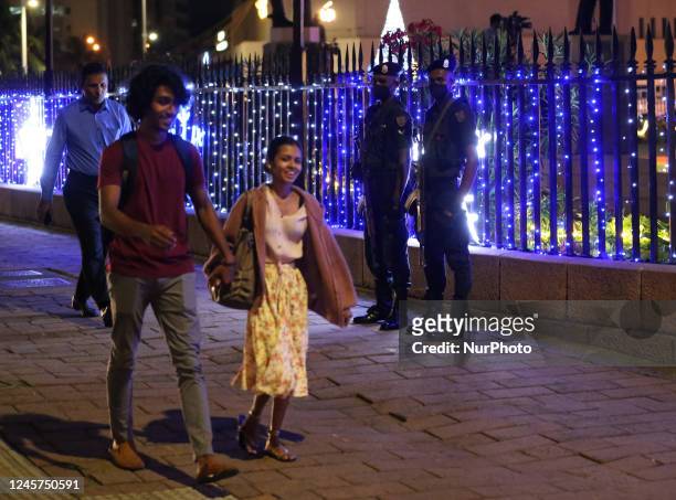 Sri Lanka Army soldiers stand guard as the Presidential Secretariat is illuminated with Christmas lights in Colombo, Sri Lanka on December 20, 2020.