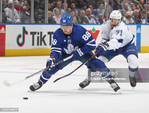 Anthony Cirelli of the Tampa Bay Lightning skates to contain William Nylander of the Toronto Maple Leafs during the first period of an NHL game at...