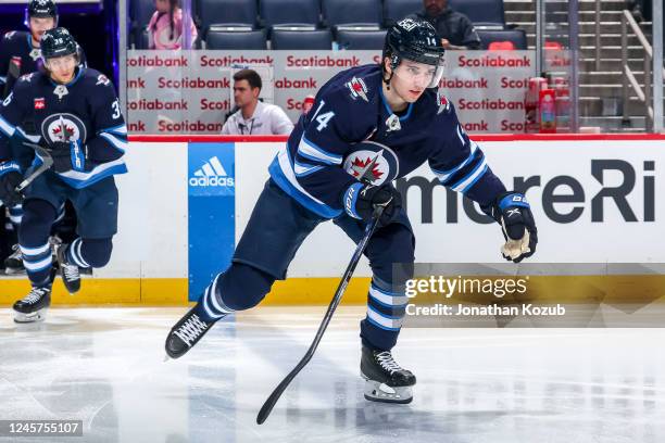 Ville Heinola of the Winnipeg Jets hits the ice prior to puck drop against the Ottawa Senators at the Canada Life Centre on December 20, 2022 in...
