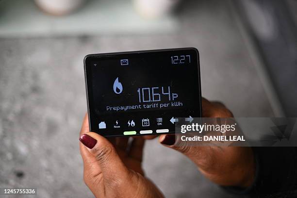 Samantha Pierre-Joseph shows her smart meter indicating that she is on a 'Prepayment tariff', in her house in London, on December 13, 2022. -...