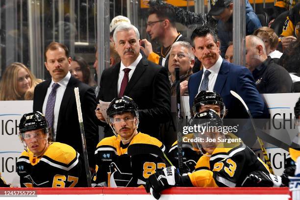 Ty Hennes, Mike Vellucci, Mike Sullivan of the Pittsburgh Penguins look on against the New York Rangers at PPG PAINTS Arena on December 20, 2022 in...