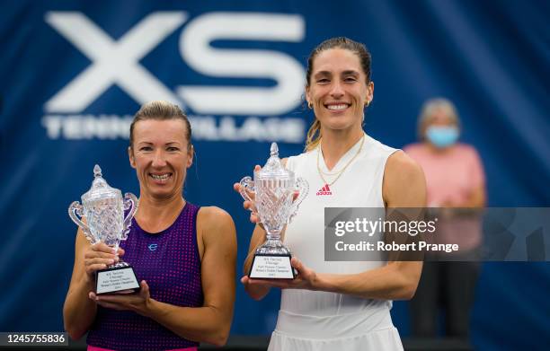 Kveta Peschke of the Czech Republic and Andrea Petkovic of Germany pose with their champions trophies after defeating Coco Vandeweghe of the United...