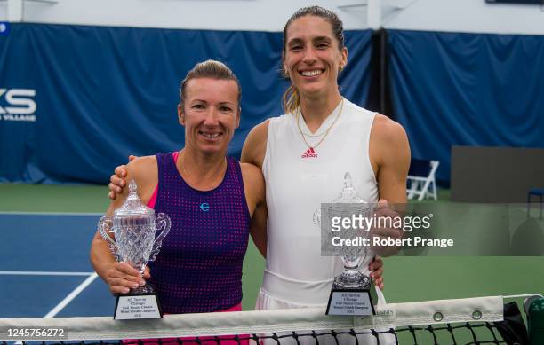 Kveta Peschke of the Czech Republic and Andrea Petkovic of Germany pose with their champions trophies after defeating Coco Vandeweghe of the United...
