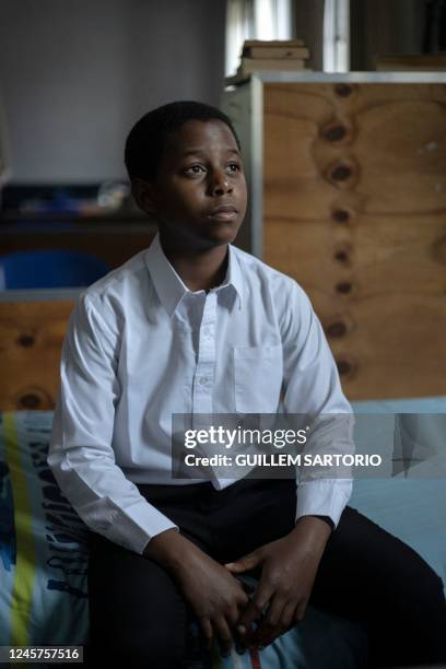 Ethan Palagangwe, a student at the Drakensberg Boys Choir School, poses for a portrait in his bedroom near Winterton on December 9, 2022. - The...