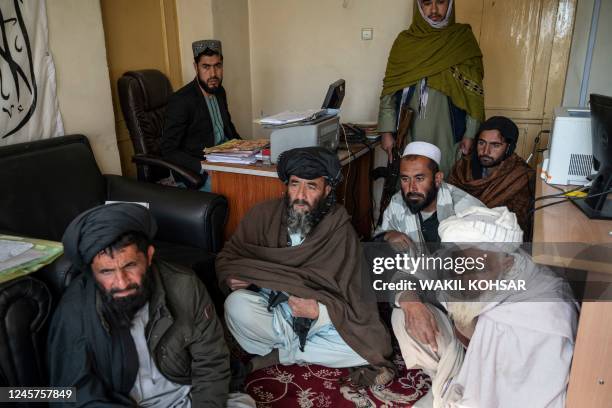 In this photo taken on November 27 Afghan petitioners gather in the civil court office at the Ghazni Court of Appeal in Ghazni, eastern Afghanistan....