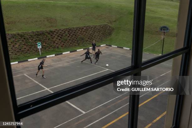 Students at the Drakensberg Boys Choir School play football during a break in between rehearsals at the school near Winterton on December 9, 2022. -...