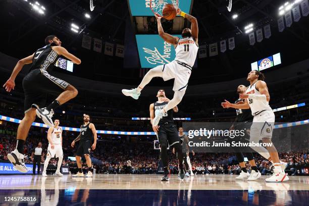 Bruce Brown of the Denver Nuggets dunks against the Memphis Grizzlies in the first quarter at Ball Arena on December 20, 2022 in Denver, Colorado....