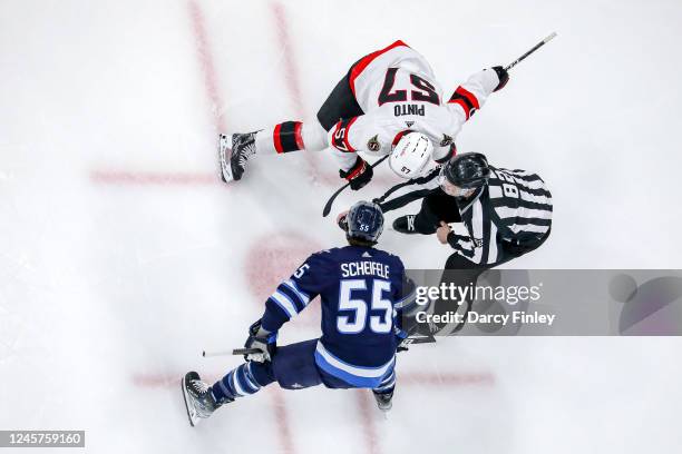 Shane Pinto of the Ottawa Senators gets set to take second period face-off against Mark Scheifele of the Winnipeg Jets at the Canada Life Centre on...