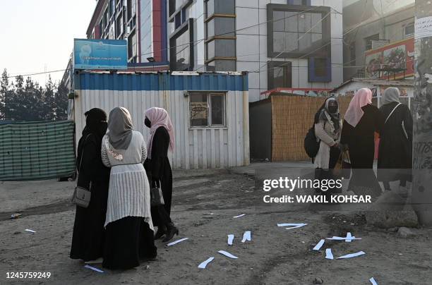 Afghan female university students walk on their on way back home past a private university in Kabul on December 21, 2022. - Afghanistan's Taliban...