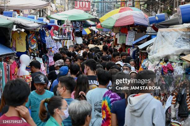 People shop along Divisoria in Manila on December 21 ahead of Christmas day.