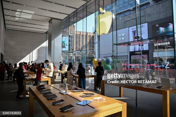 Customers are seen inside of an Apple store in the Huangpu district in Shanghai on December 21, 2022.