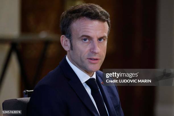 France's President Emmanuel Macron looks on during a working lunch at the royal Al-Husseiniya Palace in Amman on December 21 as Jordan hosts a Middle...