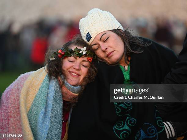 Two woman hug one another as people gather to witness the winter solstice on December 21, 2022 in Newgrange, Ireland. Crowds are gathering at...