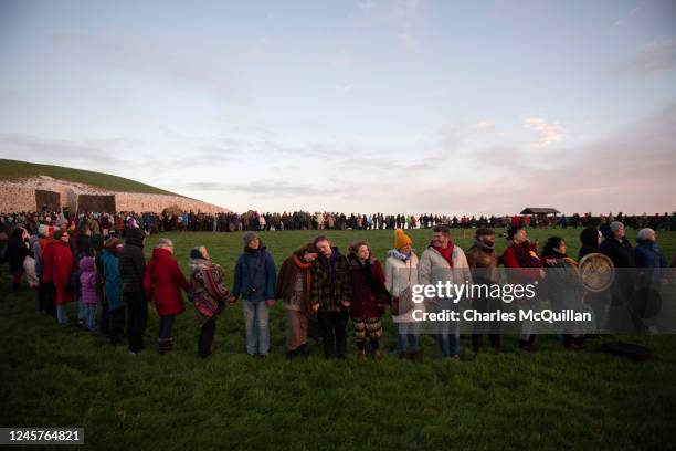 People gather in a circle to witness the winter solstice on December 21, 2022 in Newgrange, Ireland. Crowds are gathering at Newgrange in Co Meath,...