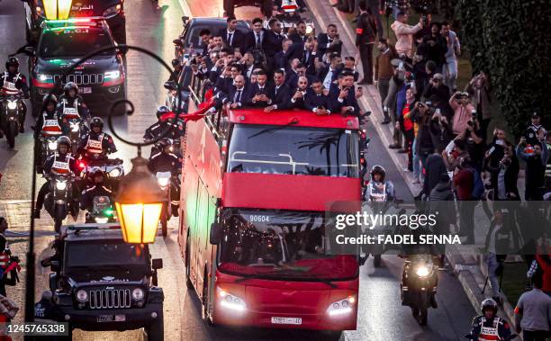 Supporters cheer as Morocco's national football team arrives to the center of the capital Rabat, on December 20 after the Qatar 2022 World Cup.