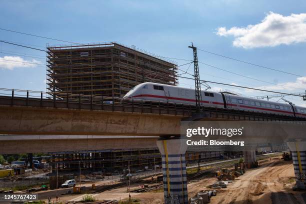 An Intercity Express passenger train passes the Quartier Heidestrasse residential and commercial project, by Aggregate Holdings SA, under...