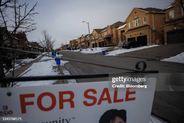 For Sale" sign outside a home in Vaughan, Canada, on Tuesday, Dec. 20. 2022. Canadian home prices fell for a ninth straight month as sharply rising...