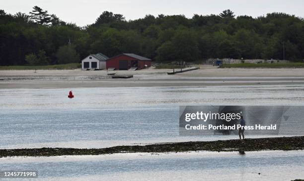 Fisherman fishes from a sandbar in the Nonesuch River at Pine Point in Scarborough Tuesday, July 5, 2022.