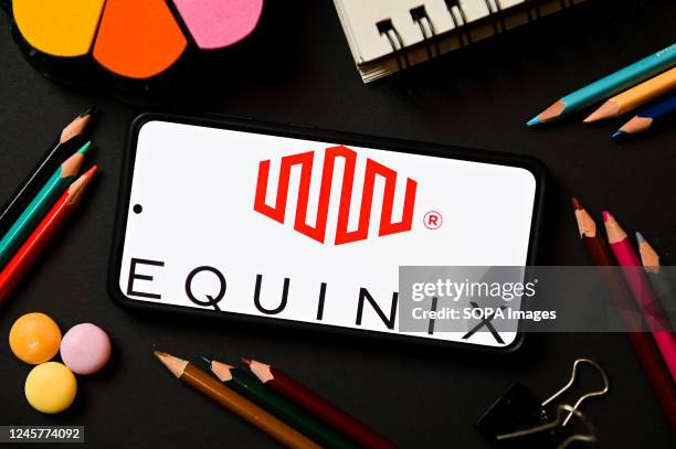 In this photo illustration an Equinix logo seen displayed on a smartphone.
