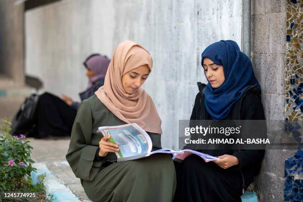 Yemeni women read books at a university in Yemen's third city of Taiz, on December 15, 2022. - Yemeni society, although deeply conservative, has...