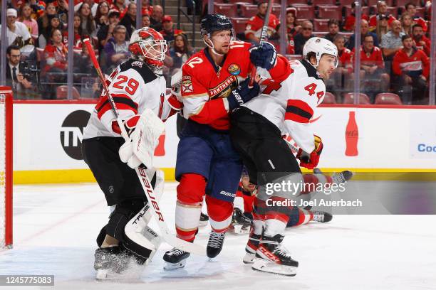 Miles Wood of the New Jersey Devils defends against Eric Staal of the Florida Panthers in front of goaltender MacKenzie Blackwood during first period...