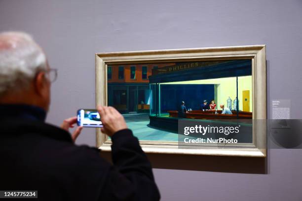 Visitor takes a picture of 'Nighthawks' painting by Edward Hopper at Art Institute of Chicago in Chicago, Illinois, United States, on October 17,...