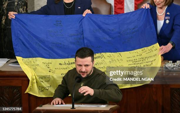 Ukraine's President Volodymyr Zelensky speaks after giving a Ukrainian national flag to US House Speaker Nancy Pelosi and US Vice President Kamala...