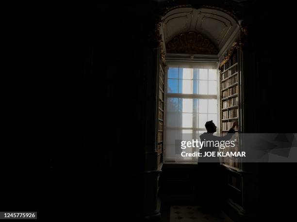 Father Maximilian Schiefermueller is seen in the library of the Benedictine Abbey in Admont, Austria on December 6, 2022. - The Admont abbey library...