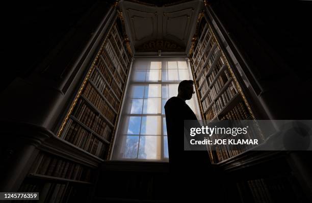 Father Maximilian Schiefermueller is seen in the library of the Benedictine Abbey in Admont, Austria on December 6, 2022. - The Admont abbey library...