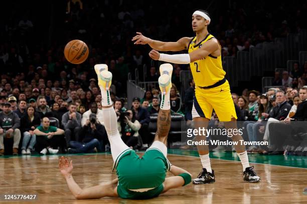 Andrew Nembhard of the Indiana Pacers throws a pass past a fallen Jayson Tatum of the Boston Celtics during the second half at TD Garden on December...