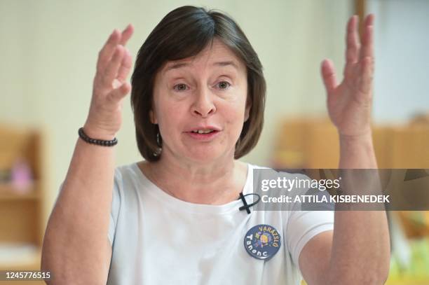 Picture taken on December 14, 2022 shows child development specialist Valeria Toth wearing a badge reading "Sorcerer's apprentice" during an AFP...