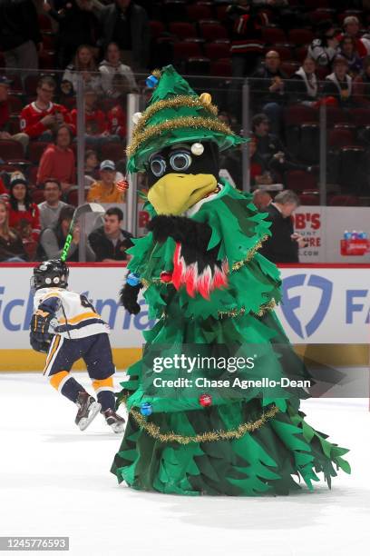 The Chicago Blackhawks mascot "Tommy Hawk" skates on the ice as a Christmas tree in between periods of the game between the Chicago Blackhawks and...