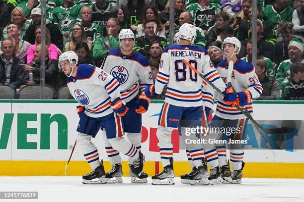Mattias Janmark, Markus Niemelainen and Ryan Nugent-Hopkins of the Edmonton Oilers celebrate a goal against the Dallas Stars at the American Airlines...