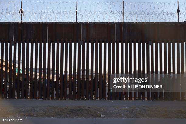 Migrants line up to be processed by US Border Patrol under the Stanton St. Bridge after entering the US in El Paso, Texas, on December 21, 2022. -...