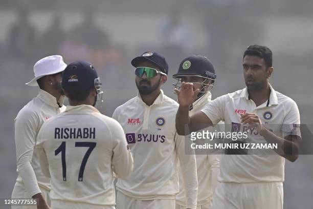 Indias Ravichandran Ashwin celebrates with teammates after taking the wicket of Bangladesh's Nazmul Hasan Santo during the first day of the second...