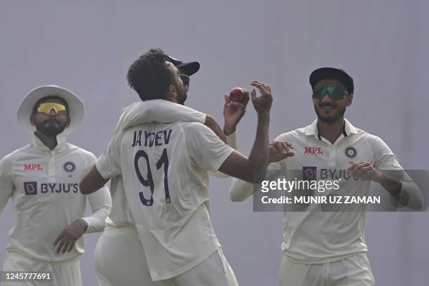 Indias Jaydev Unadkat celebrates with teammates after the dismissal of Bangladesh's Zakir Hasan during the first day of the second cricket Test match...